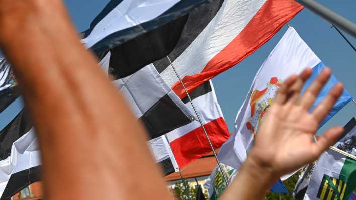 Reichsflaggen werden auf dem Magdeburger Domplatz zur Reichsbürgerkundgebung hochgehalten